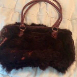 Guia’s rabbit fur handbag